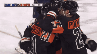 A Hockey Player With The Number 21 On His Jersey Hugs Another Player GIF