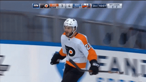 A Hockey Player With The Number 21 On His Jersey Is Holding A Hockey Stick GIF