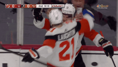 A Hockey Player With The Number 21 On His Jersey Is Hugging Another Player GIF