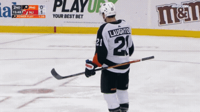A Hockey Player With The Number 21 On His Jersey Stands On The Ice GIF