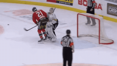A Hockey Player With The Number 21 On His Jersey Stands On The Ice GIF