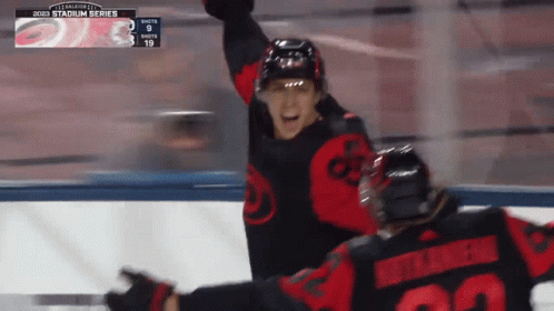 A Hockey Player With The Number 22 On His Back Celebrates A Goal GIF