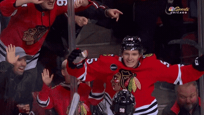 A Hockey Player With The Number 23 On His Jersey Is Hugging Two Other Players GIF