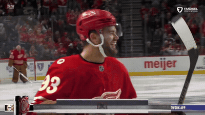 A Hockey Player With The Number 23 On His Jersey Smiles GIF