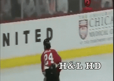 A Hockey Player With The Number 24 On His Jersey Is Skating On The Ice GIF