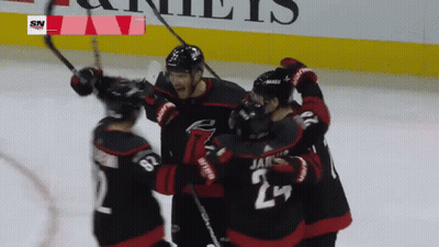 A Hockey Player With The Number 24 On His Jersey Is Surrounded By Other Players GIF