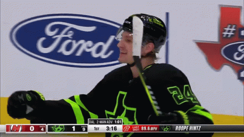 A Hockey Player With The Number 24 On His Jersey Stands In Front Of A Ford Logo GIF