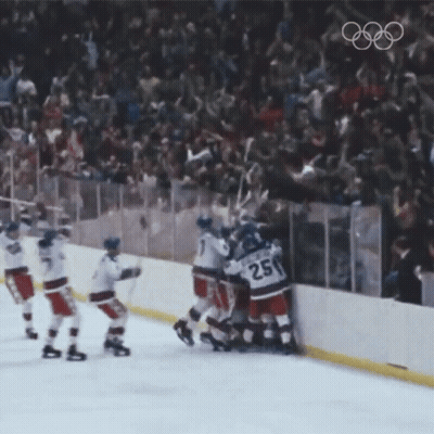 A Hockey Player With The Number 25 On His Jersey Is Surrounded By His Teammates GIF