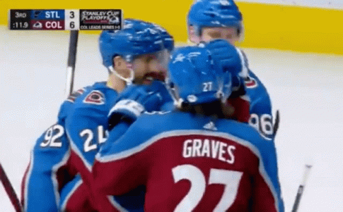 A Hockey Player With The Number 27 On His Back Is Hugging His Teammates GIF