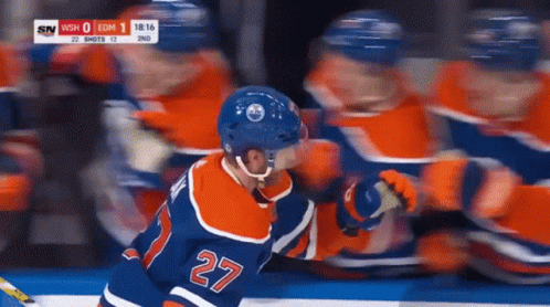 A Hockey Player With The Number 27 On His Back GIF