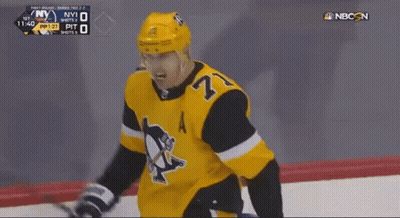A Hockey Player With The Number 27 On His Jersey Stands On The Ice GIF