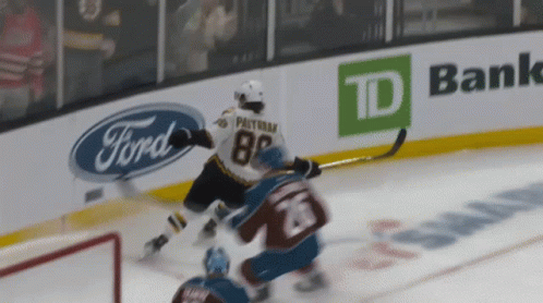 A Hockey Player With The Number 28 On His Jersey Is Being Chased By Another Player GIF
