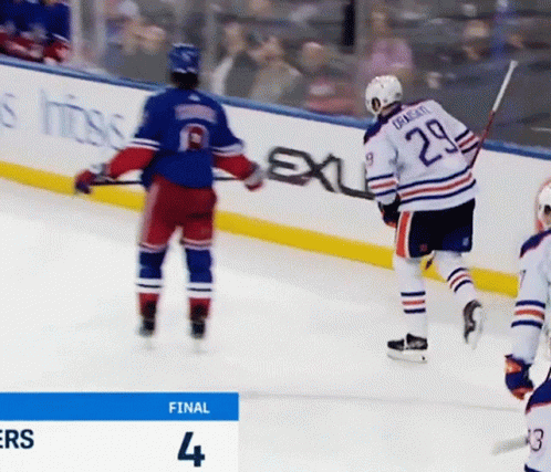 A Hockey Player With The Number 29 On His Back Stands On The Ice GIF