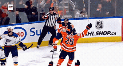 A Hockey Player With The Number 29 On His Jersey Celebrates His Goal GIF