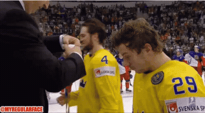 A Hockey Player With The Number 29 On His Jersey Stands Next To Another Player GIF