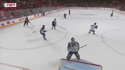 A Hockey Player With The Number 30 On His Jersey Stands On The Ice GIF
