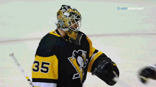 A Hockey Player With The Number 35 On His Jersey Talks To Another Player GIF