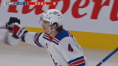 A Hockey Player With The Number 4 On His Jersey Celebrates His Goal GIF