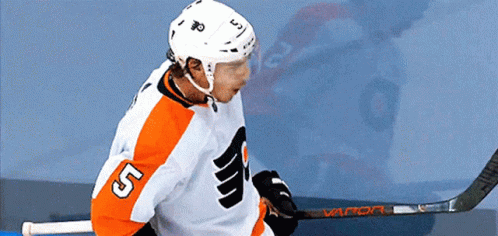 A Hockey Player With The Number 5 On His Jersey Holds A Hockey Stick GIF