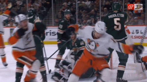 A Hockey Player With The Number 5 On His Jersey Is Being Chased By Another Player GIF