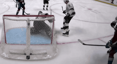A Hockey Player With The Number 5 On His Jersey Stands In Front Of The Net GIF