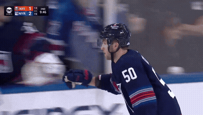 A Hockey Player With The Number 50 On His Jersey Stands On The Ice GIF