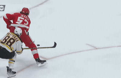 A Hockey Player With The Number 55 On His Back GIF