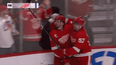 A Hockey Player With The Number 57 On His Back GIF