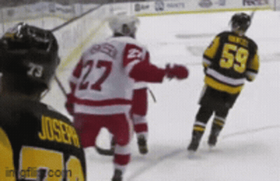 A Hockey Player With The Number 59 On His Back Stands On The Ice GIF