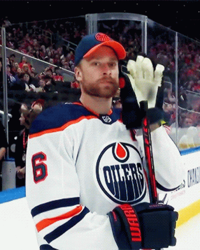 A Hockey Player With The Number 6 On His Jersey Is Holding A Stick GIF