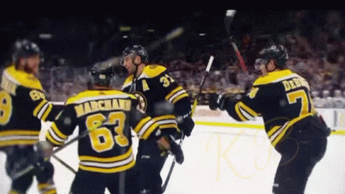 A Hockey Player With The Number 63 On His Jersey Is Surrounded By His Teammates GIF