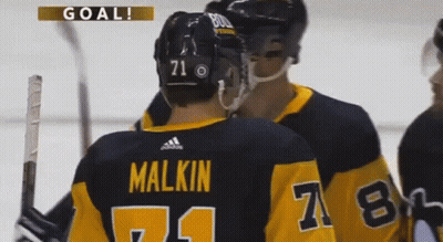 A Hockey Player With The Number 71 On His Back GIF