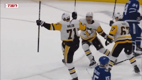 A Hockey Player With The Number 71 On His Jersey Celebrates With His Teammates GIF