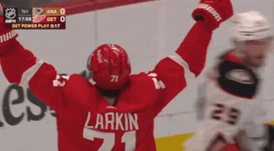 A Hockey Player With The Number 71 On His Jersey Is Celebrating GIF