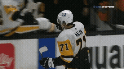 A Hockey Player With The Number 71 On His Jersey Stands On The Ice GIF