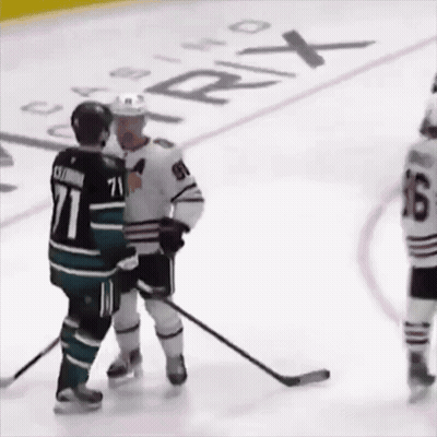 A Hockey Player With The Number 71 On His Jersey Talks To Another Player GIF