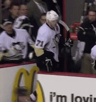 A Hockey Player With The Number 71 On His Shirt GIF