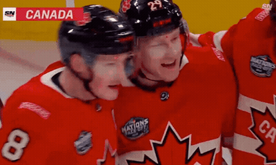 A Hockey Player With The Number 8 On His Jersey Hugs Another Player GIF