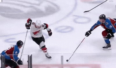 A Hockey Player With The Number 8 On His Jersey Is Playing Against Another Player GIF