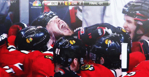 A Hockey Player With The Number 81 On His Helmet Is Surrounded By Other Players GIF