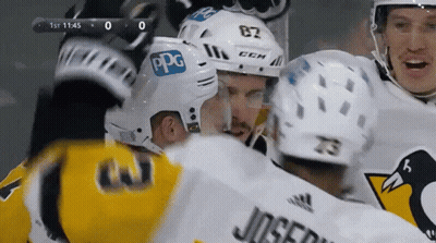 A Hockey Player With The Number 82 On His Helmet Is Surrounded By Other Players GIF