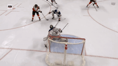 A Hockey Player With The Number 85 On His Jersey Is Skating On The Ice GIF