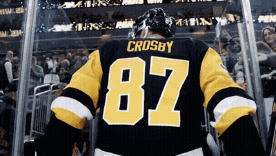 A Hockey Player With The Number 87 On His Back GIF
