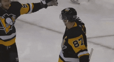 A Hockey Player With The Number 87 On His Jersey Stands On The Ice GIF