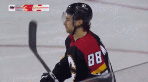 A Hockey Player With The Number 88 On His Back Stands On The Ice GIF
