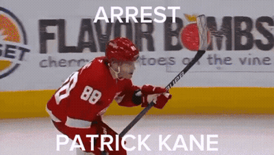 A Hockey Player With The Number 88 On His Jersey Is Holding A Hockey Stick GIF