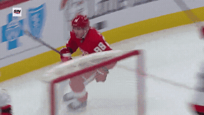 A Hockey Player With The Number 88 On His Jersey Is Skating On The Ice GIF