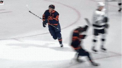 A Hockey Player With The Number 9 On His Jersey Is Holding A Stick GIF