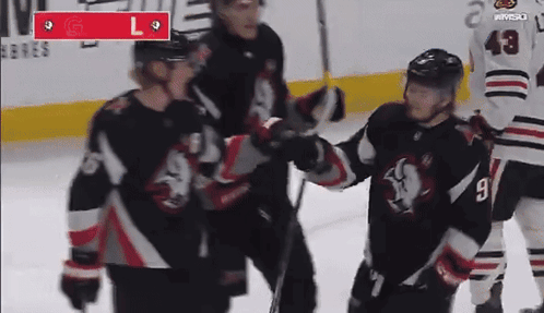 A Hockey Player With The Number 9 On His Jersey Stands On The Ice GIF