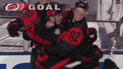 A Hockey Player With The Number 92 On His Jersey Is Hugging Another Player GIF